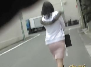 Asian babe has her panties pulled during street sharking.