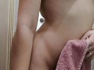 The girl with red hair got out of the shower and showed off her boobs