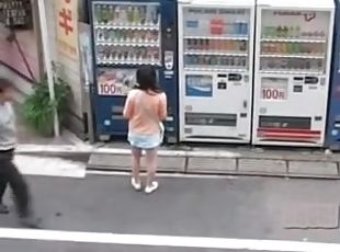 Asian schoolgirl street sharked at the vending machine.