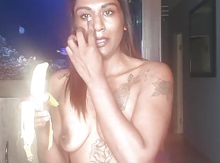 Topless desi squeezes her boobs as she sucks and deepthroats on a banana 