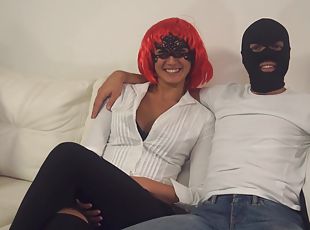 Gal in a vibrant red wig and a masked man do it up in style